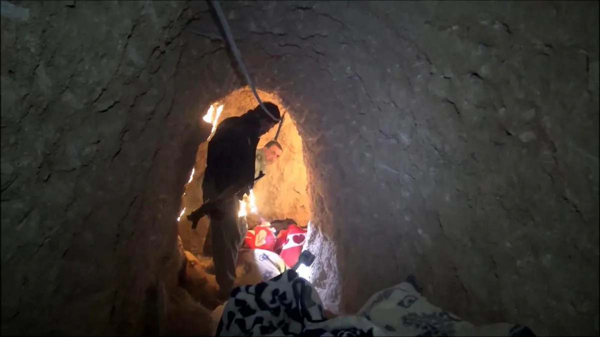 In this image made from video taken on Sunday, Nov. 22, 2015, Kurdish security forces are seen in a tunnel complex under the city of Sinjar, northern Iraq that were used by Islamic State extremists to move undetected and avoid coalition airstrikes. (AP Photo via AP video)