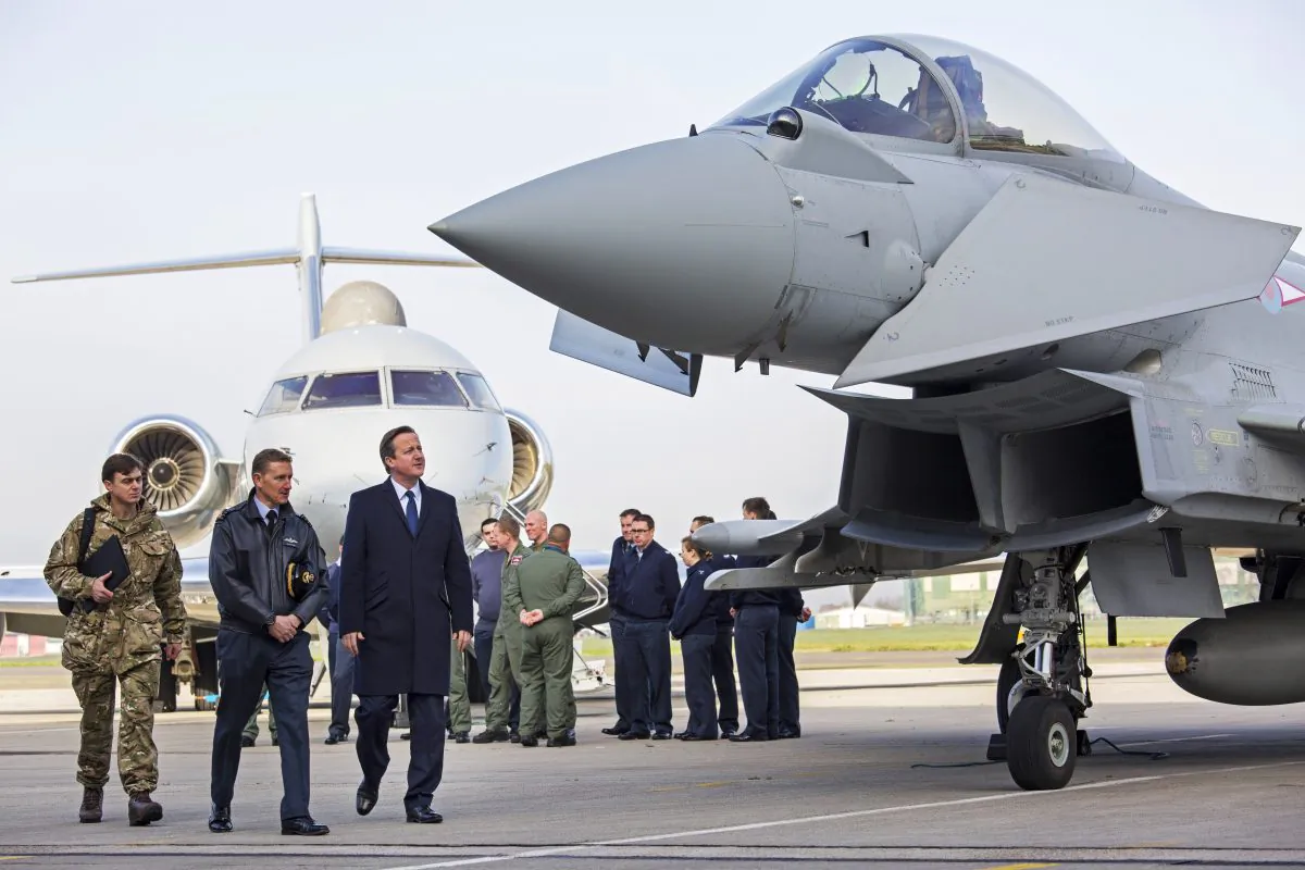 British Prime Minister David Cameron at RAF Northolt, London. He stopped to talk to service personal and view military hardware on his way back from visiting President Hollande in Paris and is ahead of the SDSR statement on Nov. 23, 2015. (Jack Hill)