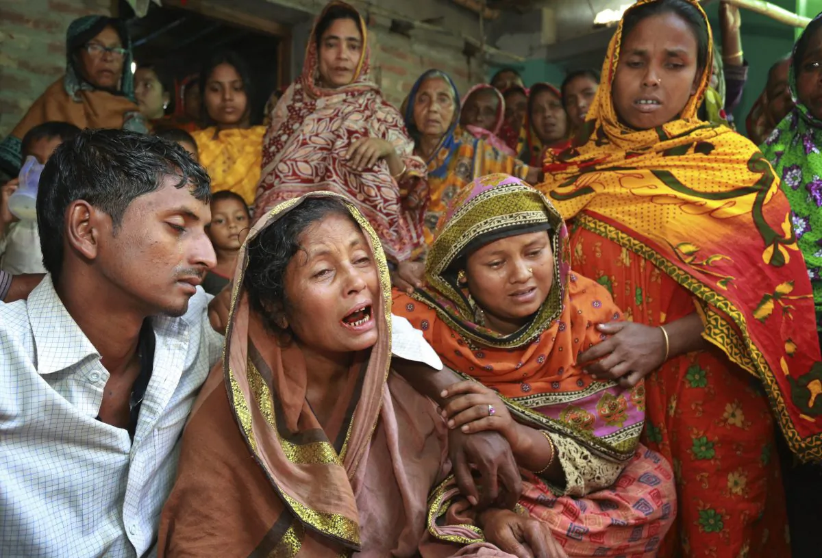 Relatives of people killed as unidentified gunmen attacked a mosque during evening prayers on Thursday, grieve before their funeral in Bangladesh's Bogra district, Friday, Nov. 27, 2015. (AP Photo)
