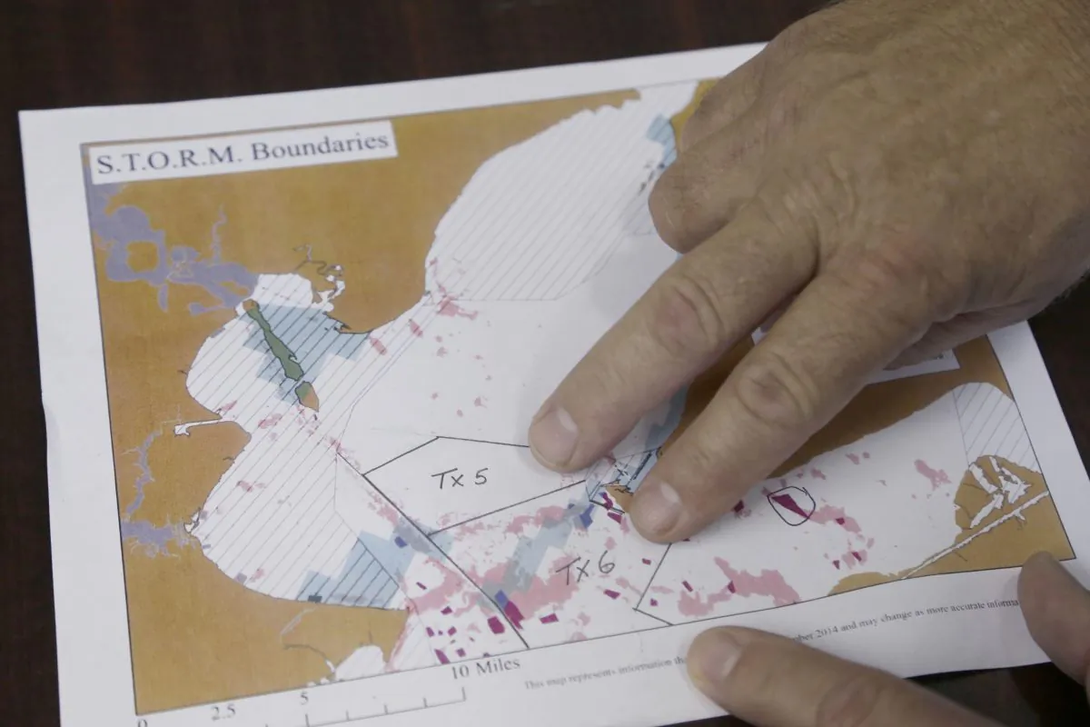 Oyster fisherman Tracy Woody points out some of the areas of existing oyster beds and the areas he has leased, in the processing plant he runs in Smith Point, Texas, on Nov. 6, 2015. Woody last year reached a 30-year agreement with the Chambers-Liberty Counties Navigation District for access to 23,000 acres of Gulf seabed owned by the district. Woody says he wants to cultivate and harvest oysters, while making the beds more sustainable. Competitors say his efforts are an unlawful attempt to seize control of water and monopolize a prized commodity. (AP Photo/Pat Sullivan)
