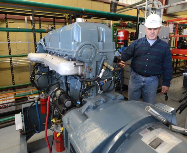 Ingenco Director of Construction Tom Hecmanczuk shows one of the engines that will run on the methane gas from the Bristol Virginia Landfill to produce electricity to sell to the TVA, Nov. 19, 2015. (David Crigger/Bristol Herald-Courier via AP)