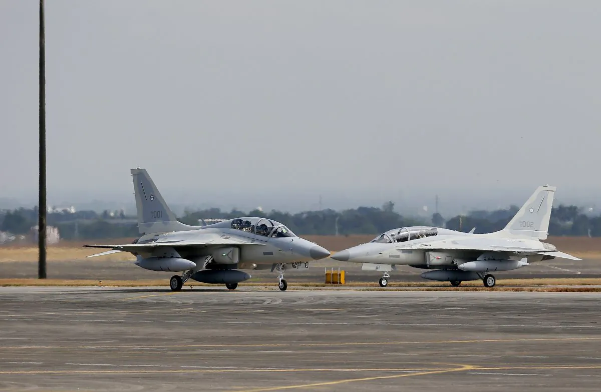 Two newly-acquired FA-50PH fighter jets taxi on the runway upon landing Saturday, Nov. 28, 2015, at Clark Air Base in Pampanga Province, north of Manila, Philippines. The first two of the 12 brand new fighter jets from South Korea arrived Saturday as part of the country's modernization program and to mark the air force's return to "supersonic jet age." (AP Photo/Bullit Marquez)
