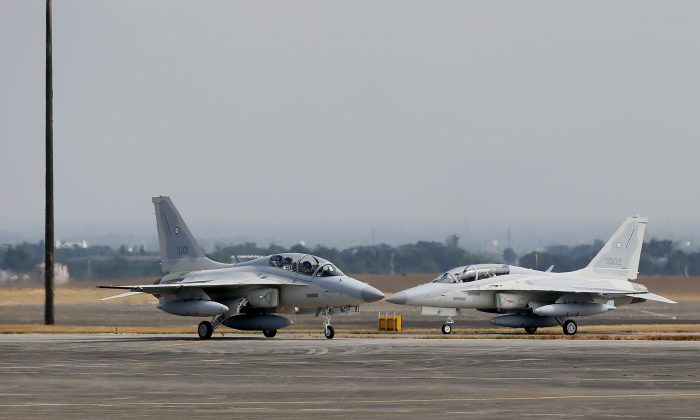 Two newly-acquired FA-50PH fighter jets taxi on the runway upon landing Saturday, Nov. 28, 2015, at Clark Air Base in Pampanga Province, north of Manila, Philippines. The first two of the 12 brand new fighter jets from South Korea arrived Saturday as part of the country's modernization program and to mark the air force's return to "supersonic jet age." (AP Photo/Bullit Marquez)
