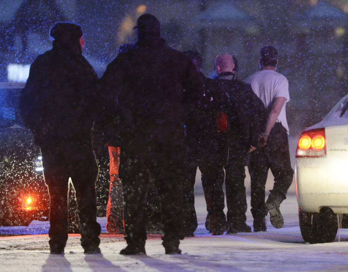 Police take a man into custody near a Planned Parenthood clinic in Colorado Springs, Colo., Friday, Nov. 27, 2015. A gunman opened fire at the clinic on Friday, authorities said, wounding multiple people. (Andy Cross/The Denver Post via AP)