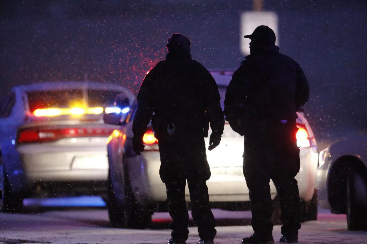 Police officers stand guard near the scene of a shooting at a Planned Parenthood clinic in Colorado Springs, Colo., Friday, Nov. 27, 2015. A gunman opened fire at the clinic on Friday, authorities said, wounding multiple people. (AP Photo/David Zalubowski)