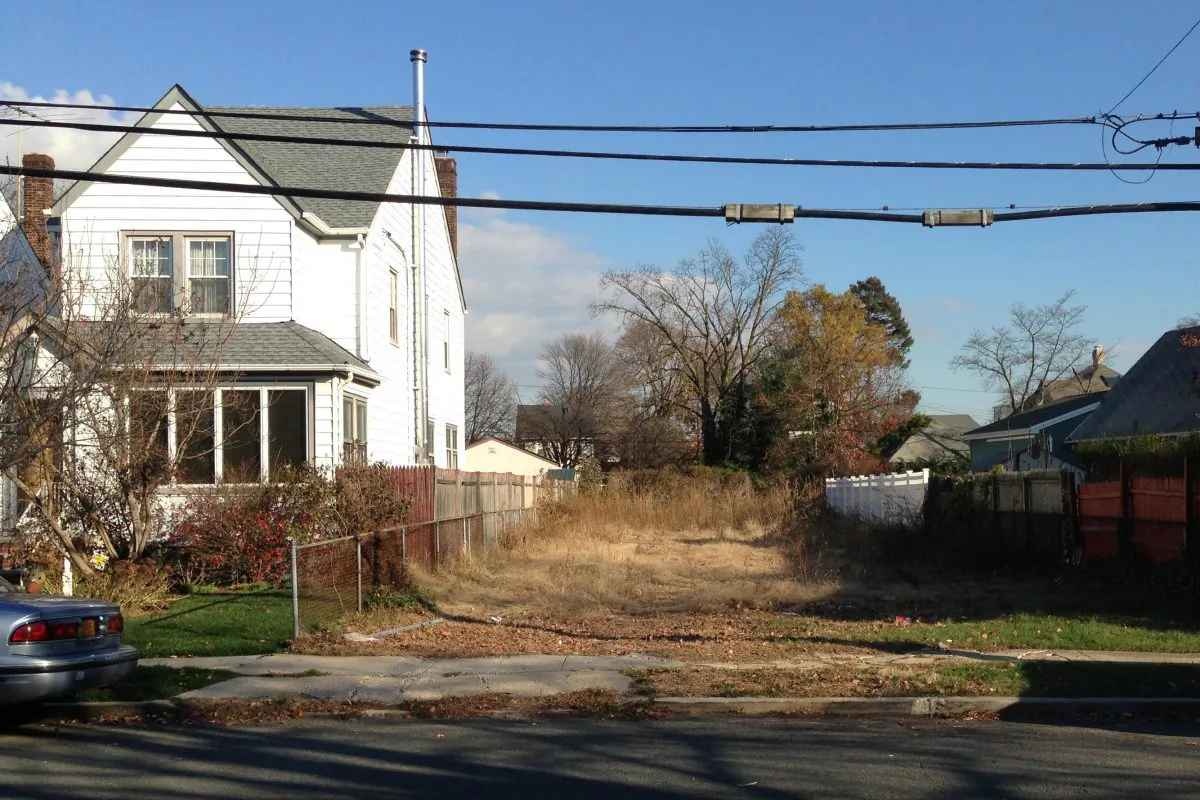 In this photo of Nov. 25, 2015, a lot stands empty in West Hempstead, N.Y., after the township had the home that once stood on it torn down. Homeowner Philip Williams says he went to Fort Lauderdale for the knee replacement in December, 2014. When he returned to the West Hempstead home in August 2015, his home was gone. (AP Photo/Frank Eltman)