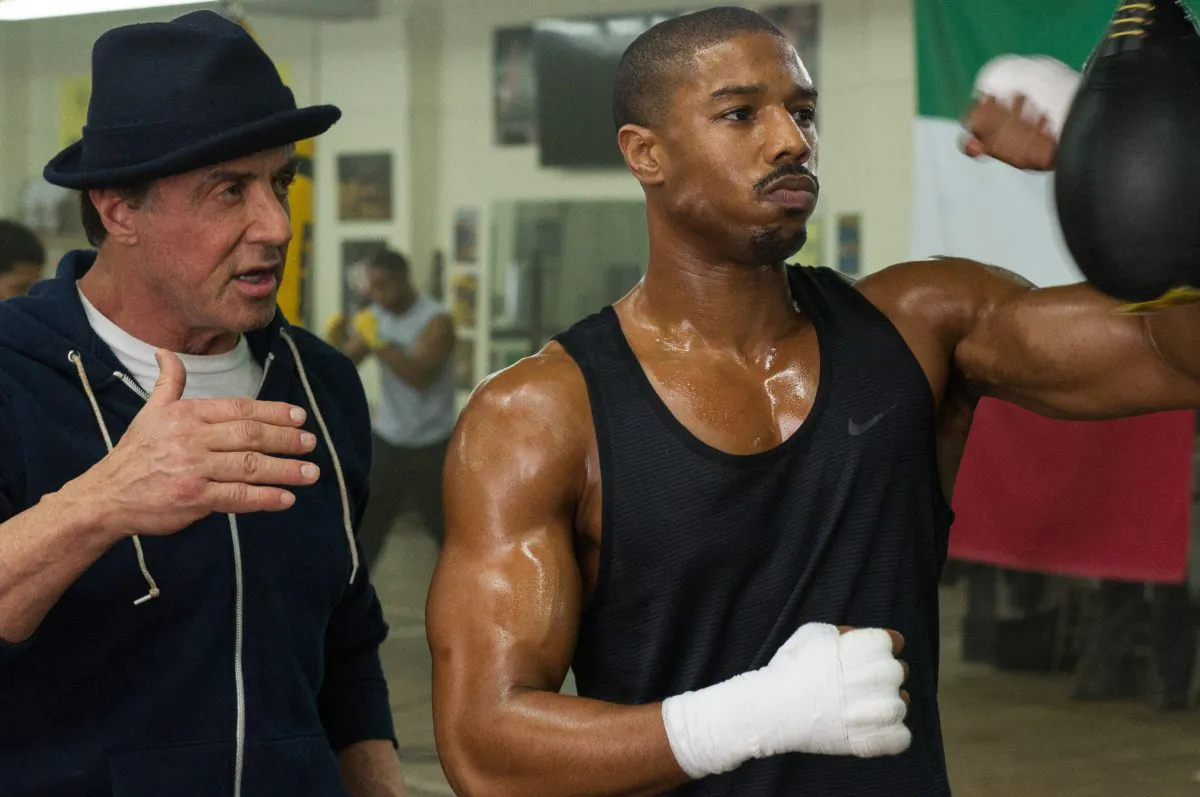 Michael B. Jordan (R) as Adonis Johnson and Sylvester Stallone as Rocky Balboa in Metro-Goldwyn-Mayer Pictures', Warner Bros. Pictures' and New Line Cinema's drama "Creed," a Warner Bros. Pictures release. The movie opened in U.S. theaters on Nov. 25, 2015. (Barry Wetcher/Warner Bros. Pictures via AP)