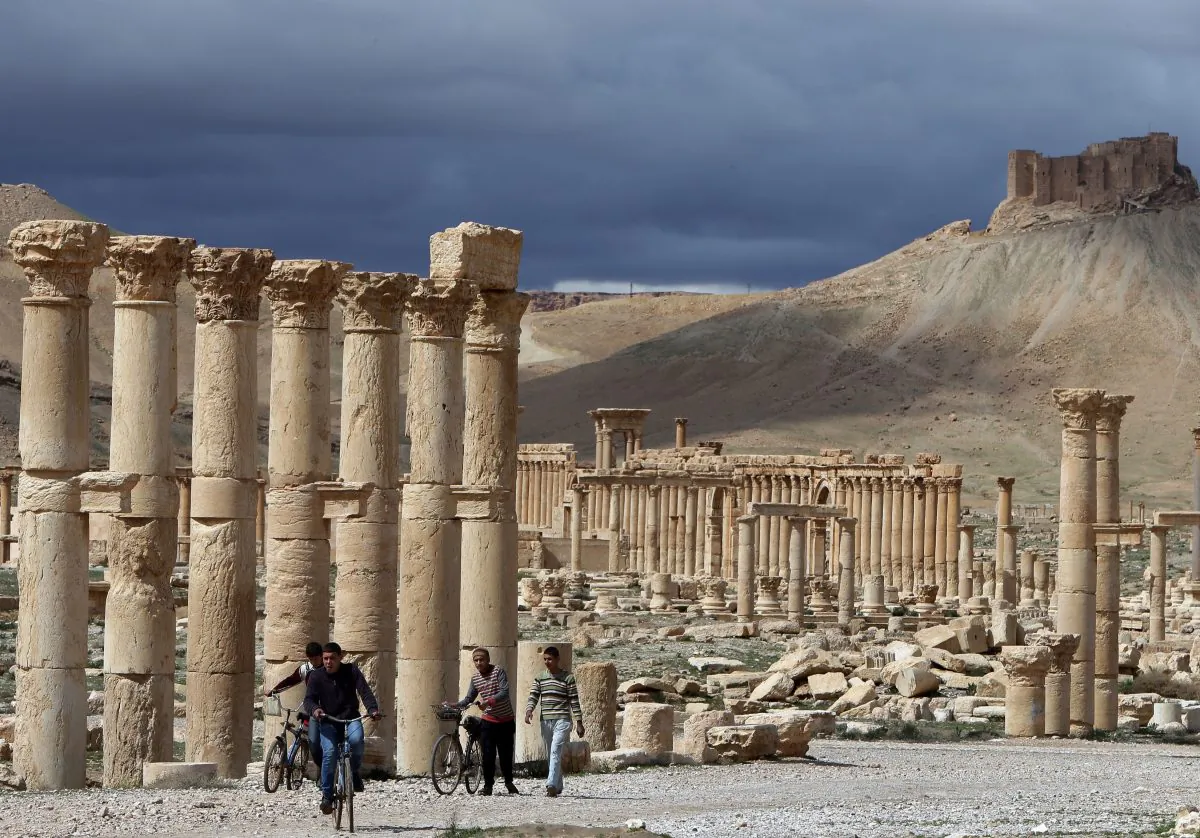 Syrian citizens riding their bicycles the ancient oasis city of Palmyra, 134 miles (215 kilometres) northeast of Damascus, on March 14, 2014. Syria's fabled desert Greco-Roman oasis of Palmyra saw its last tourist in September 2011, six months after the uprising began. Its most recent visitors are violence and looting. (Joseph Eid/AFP/Getty Images)