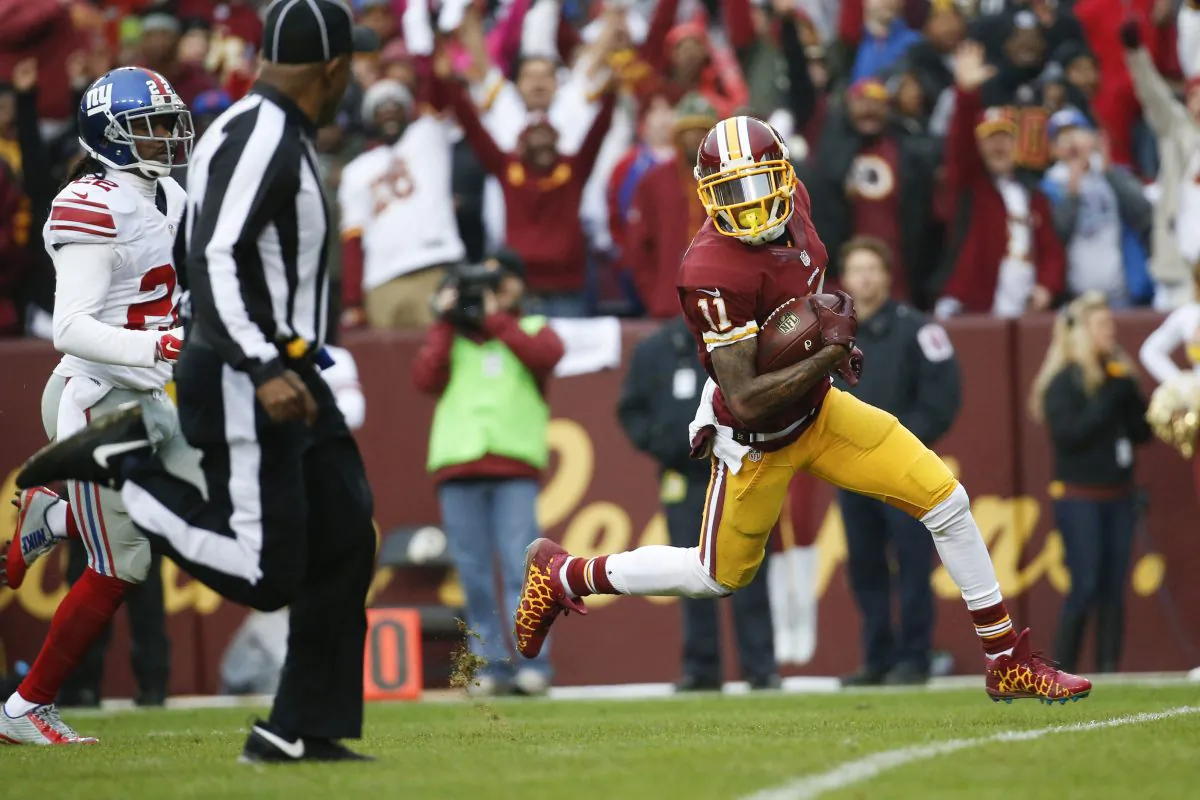 Washington Redskins wide receiver DeSean Jackson (11) carries the ball into the end zone for a touchdown after a pass reception from quarterback Kirk Cousins (8) during the first half of an NFL football game against the New York Giants in Landover, Md., Sunday, Nov. 29, 2015. (AP Photo/Alex Brandon)
