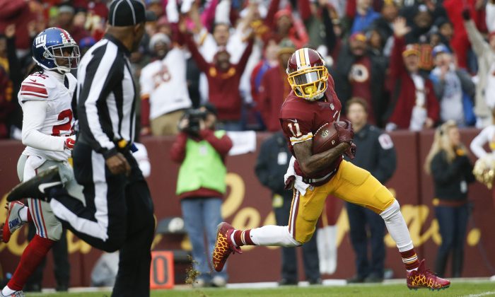 Washington Redskins wide receiver DeSean Jackson (11) carries the ball into the end zone for a touchdown after a pass reception from quarterback Kirk Cousins (8) during the first half of an NFL football game against the New York Giants in Landover, Md., Sunday, Nov. 29, 2015. (AP Photo/Alex Brandon)