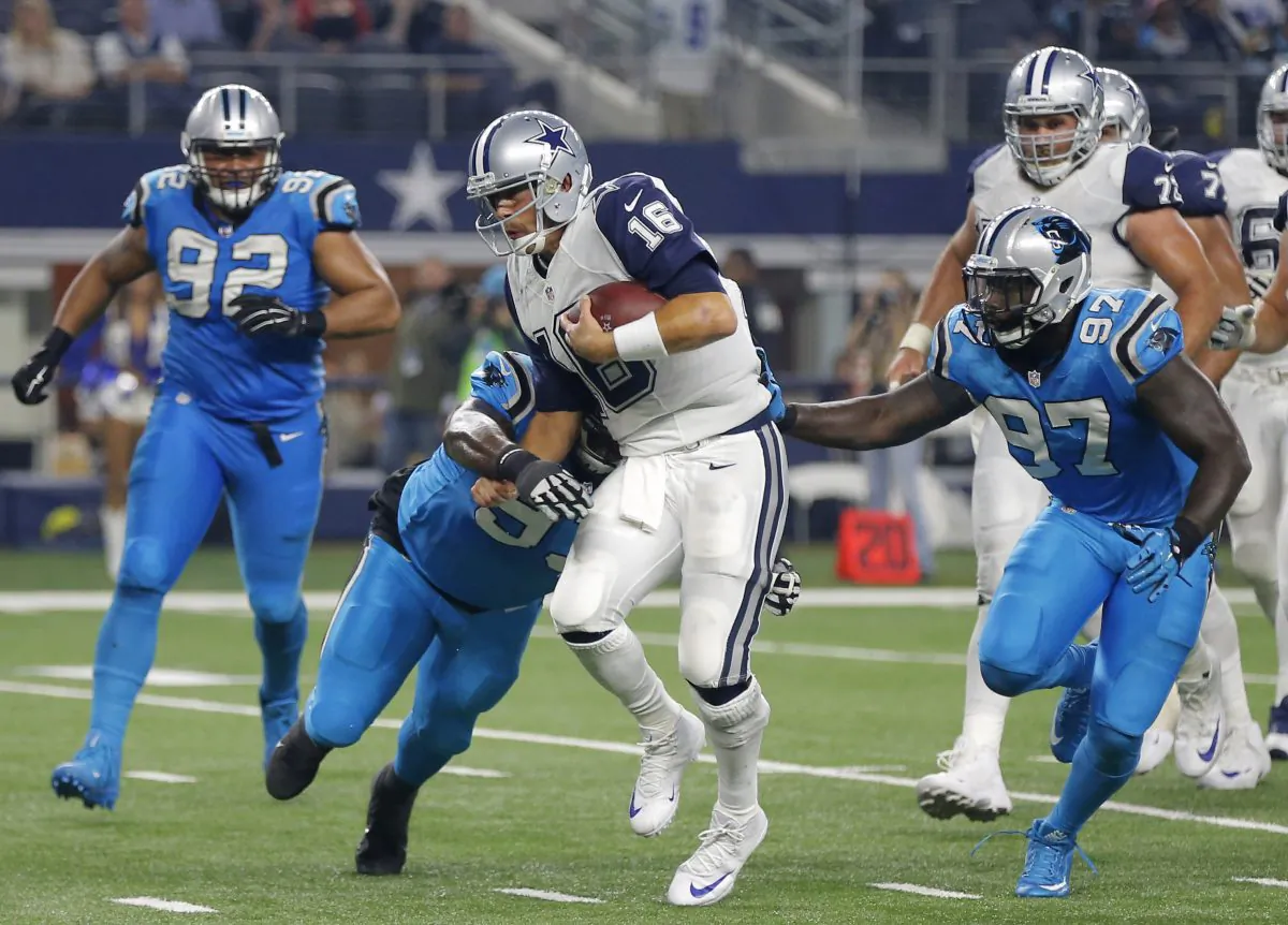 Dallas Cowboys quarterback Matt Cassel (16) is tackled by Carolina Panthers' Kyle Love (93) and Mario Addison (97) as Dwan Edwards (92) watches during the second half of an NFL football game Thursday, Nov. 26, 2015, in Arlington, Texas. (AP Photo/Brandon Wade)
