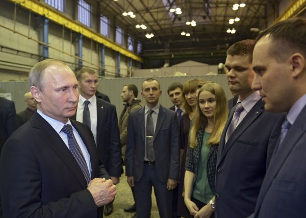 Russian President Vladimir Putin (L) meets with employees of the Ural Transport Machine Building Design Bureau during a visit to the UralVagonZavod factory in Nizhny Tagil in the Ural mountains, Russia, on Nov. 25, 2015. (Alexei Nikolsky/Sputnik via AP)