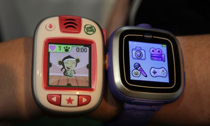 A LeapBand (L) from LeapFrog and a Kidizoom Smartwatch (R) from VTech, are displayed at the TTPM Holiday Showcase in New York on Oct. 1, 2014. (AP Photo/Richard Drew)