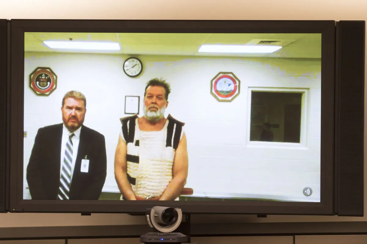 Colorado Springs Planned Parenthood shooting suspect Robert Dear, right, appears via video during his first court appearance, where he was told he faces first degree murder charges in Colorado Springs, Colo., Monday, Nov. 30, 2015. (Mark Reis/The Gazette via AP, Pool)
