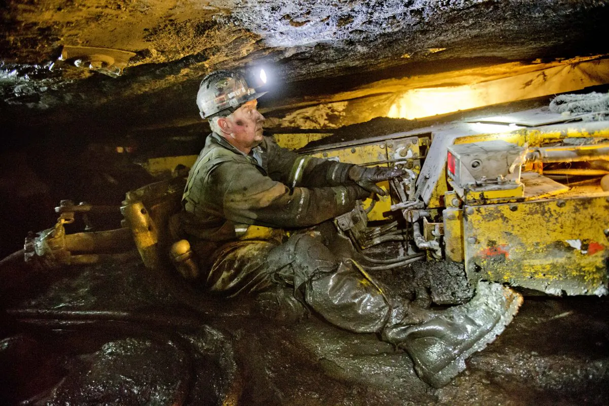 Scott Tiller, a coal miner of 31 years, operates a continuous miner machine in a coal mine roughly 40-inches-high, Tuesday, Oct. 6, 2015, in Welch, W.Va. (AP Photo/David Goldman)