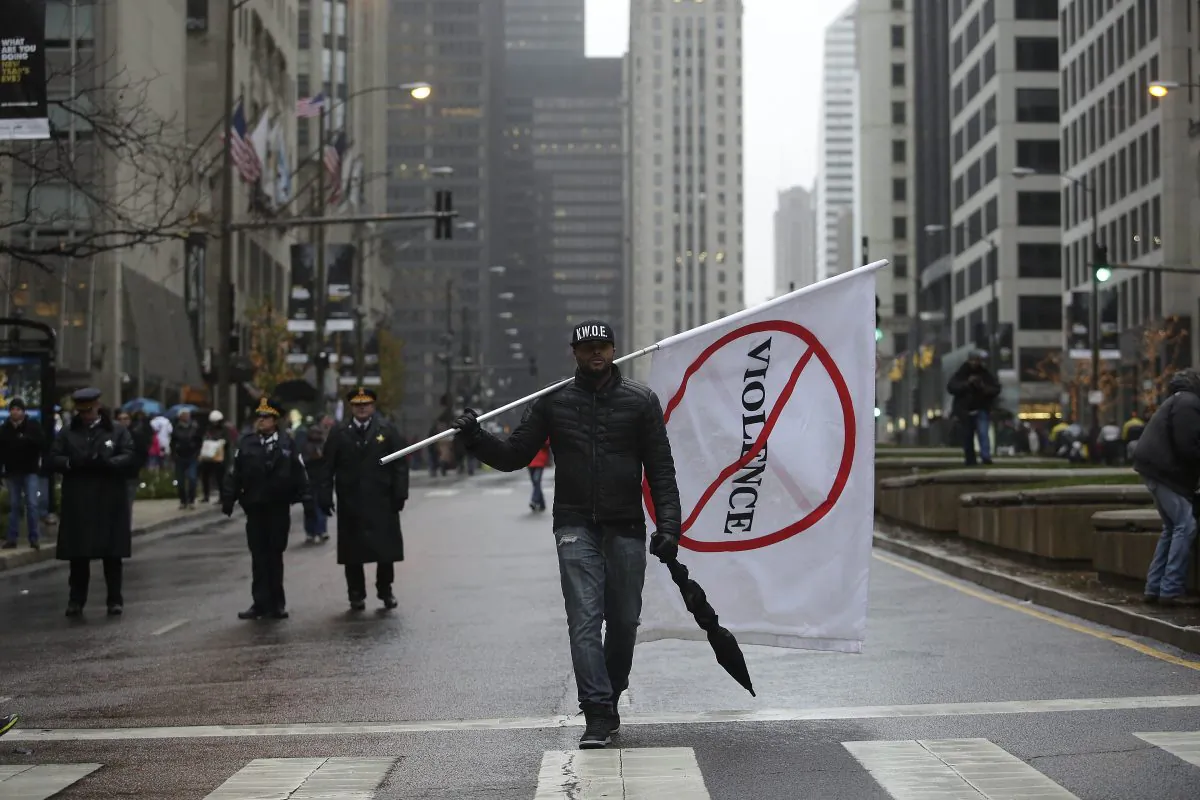 A demonstrator protesting the shooting of Laquan McDonald who was killed by a Chicago police Officer walks along Michigan Avenue also known as the Magnificent Mile in Chicago, Ill., on Nov. 27, 2015. (Joshua Lott/Getty Images)