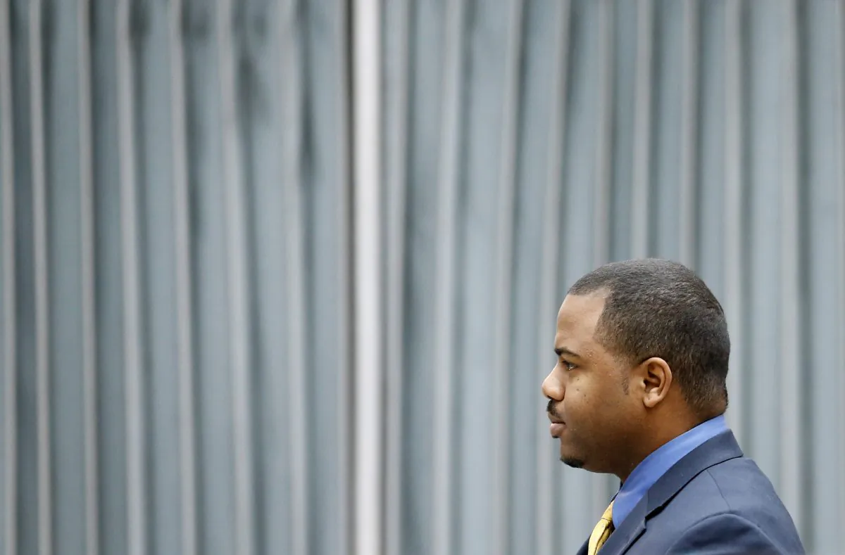 William Porter, one of six Baltimore City police officers charged in connection to the death of Freddie Gray, walks to a courthouse for jury selection in his trial in Baltimore on Monday, Nov. 30, 2015. (AP Photo/Patrick Semansky)