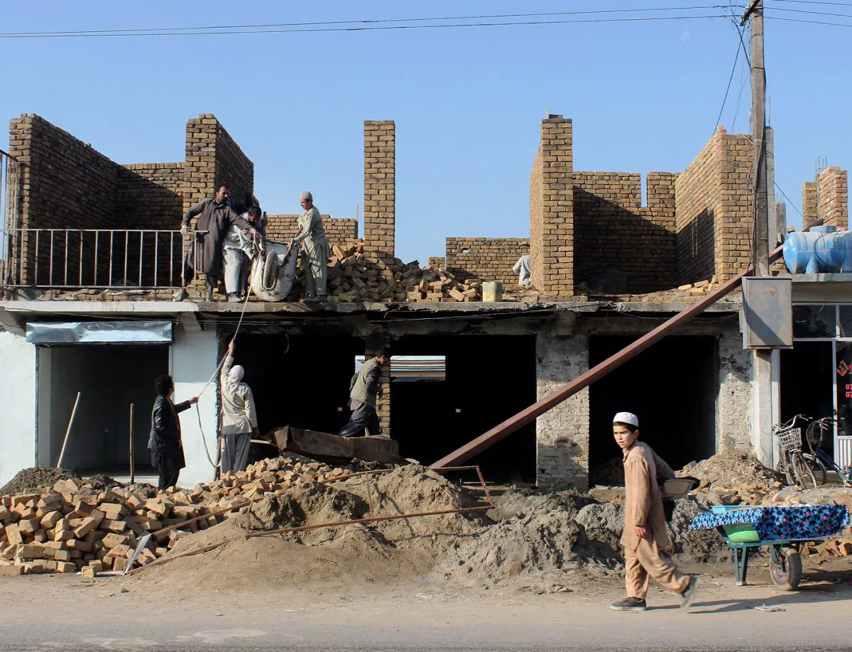 In this Tuesday, Dec. 1, 2015, photo, Afghan laborers rebuild a destroyed shop in Kunduz city, north of Kabul, Afghanistan. (AP Photo/Najim Rahim)