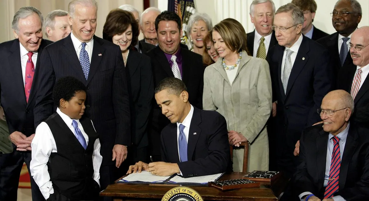 President Barack Obama signs the Affordable Care Act in the East Room of the White House in Washington, D.C., on March 23, 2010. A government report says 2014 U.S. health care spending grew at the fastest pace of President Obama’s tenure, driven by expanded coverage through his namesake law and by zooming prescription drug costs. (AP Photo/J. Scott Applewhite)