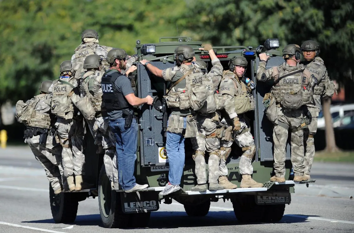 A SWAT vehicle carries police officers near the scene of a shooting in San Bernardino, Calif. on Wednesday, Dec. 2, 2015. (Micah Escamilla/Los Angeles News Group via AP)