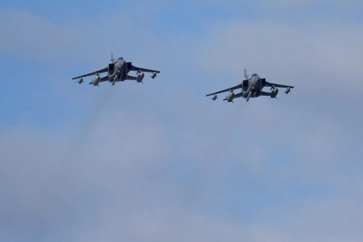 Two British Tornados warplanes fly over the RAF Akrotiri, a British air base near costal city of Limassol, Cyprus, Thursday, Dec. 3, 2015, as they arrive from an airstrike against Islamic State group targets in Syria. (AP Photo/Pavlos Vrionides)