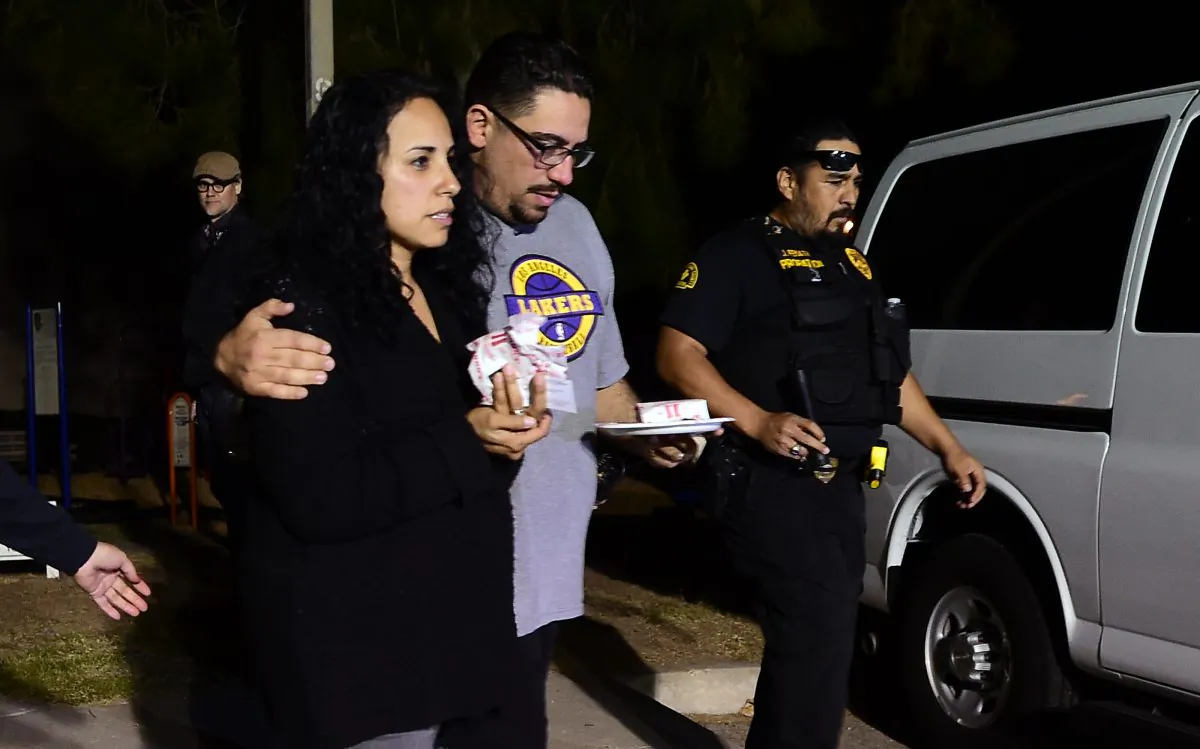 Omar Riopedre embraces his wife Diana, who was in the Inland Regional Center when the mass shootings took place, as they leave the Rudy C. Hernandez Community Center in the San Bernardino on December 2, 2015. (Frederic J. Brown/AFP/Getty Images)