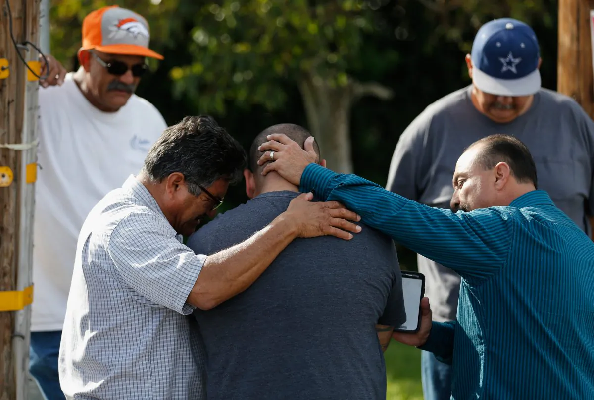 A group of men embrace in prayer outside the crime scene where the suspects in the shooting at the Inland Resource Center were killed on Dec. 3, 2015, in San Bernardino, Calif. Police continue to investigate a mass shooting at the Inland Regional Center in San Bernardino that left at least 14 people dead and another 17 injured. (Sean M. Haffey/Getty Images)