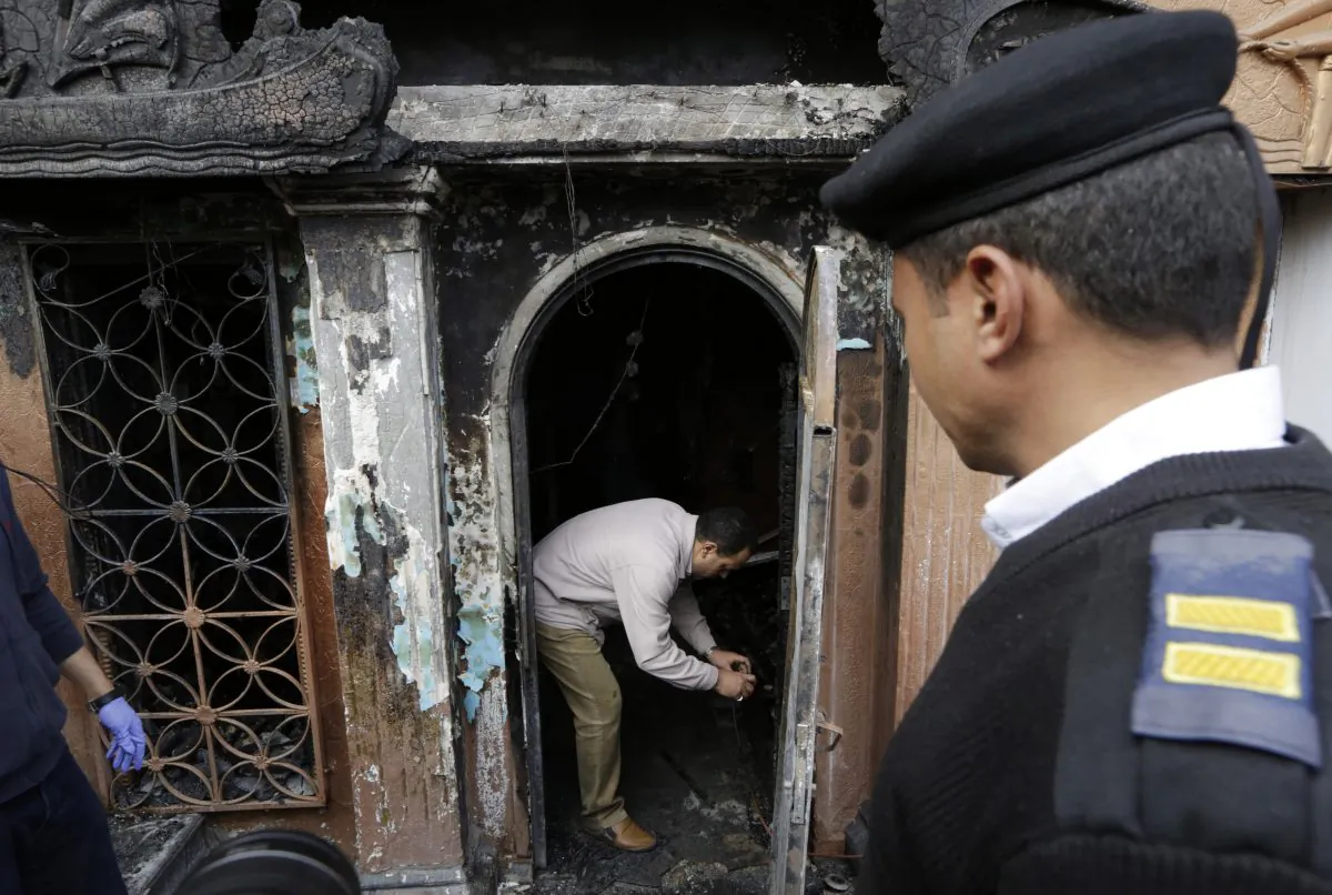 An Egyptian forensic member checks the gate of the nightclub which was attacked in Cairo, Egypt, Friday, Dec. 4, 2015. (AP Photo/Amr Nabil)