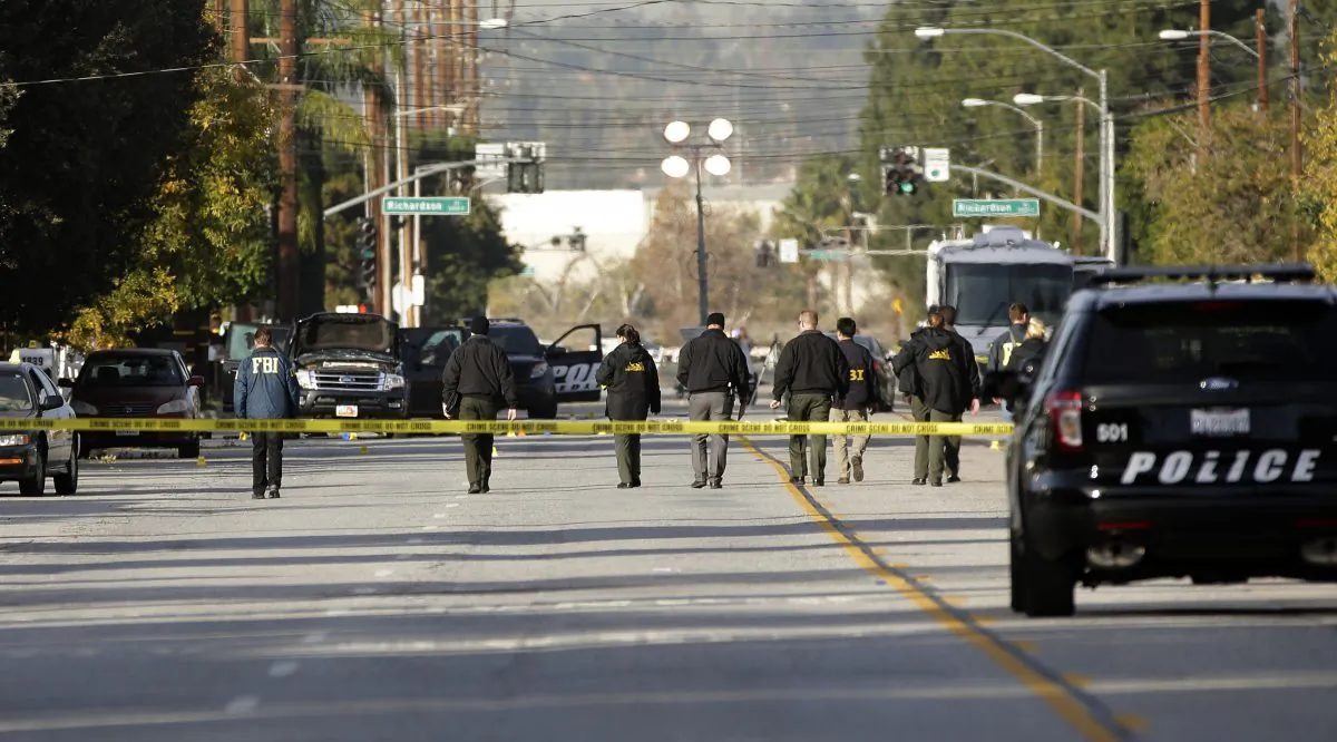 Investigators search for bullet casings at the scene where Wednesday's police shootout with suspects took place, in San Bernardino, Calif., on Dec. 3, 2015. (AP Photo/Jae C. Hong)
