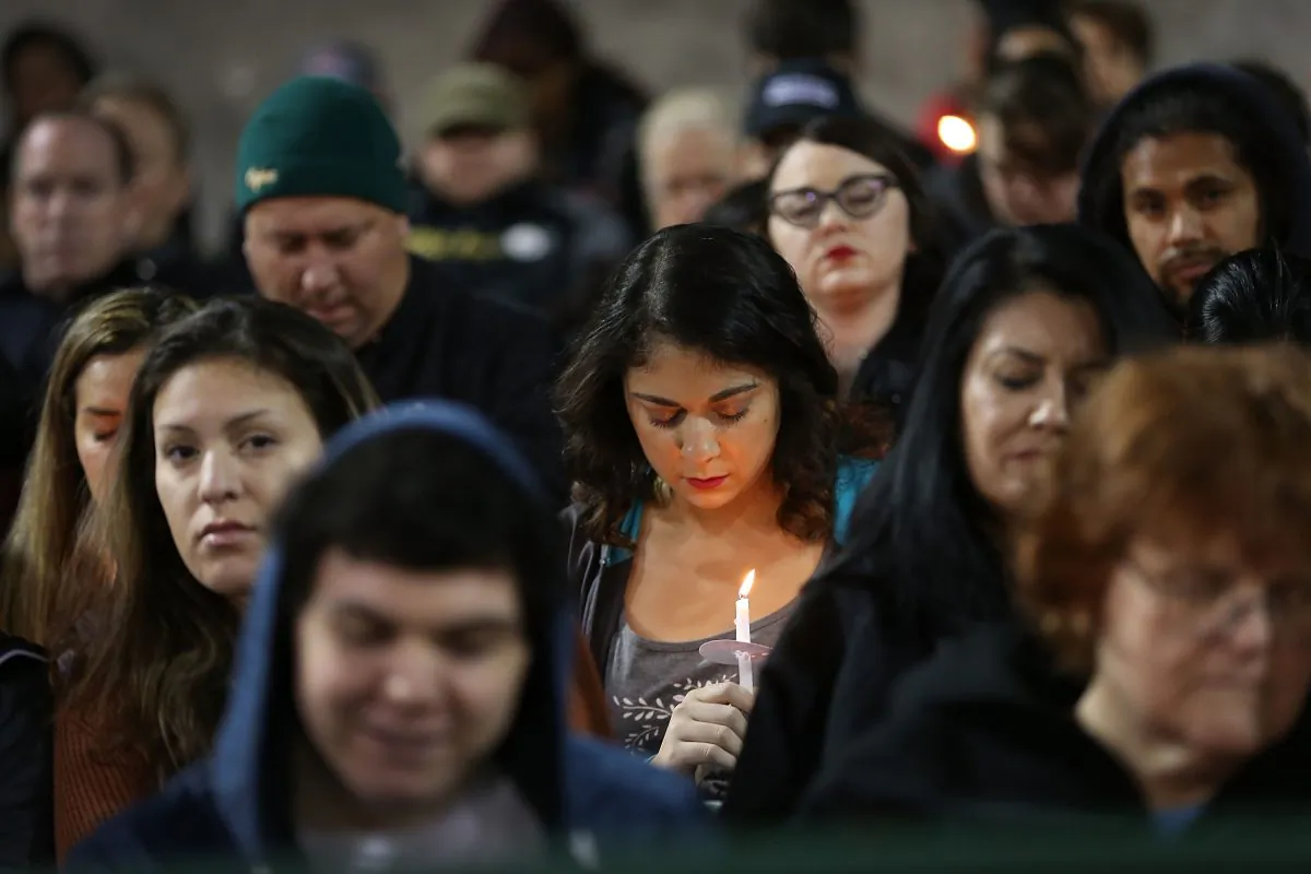 People hold candles on Dec. 3, 2015, as they attend a vigil at the San Manuel Stadium to remember those injured and killed during the shooting at the Inland Regional Center were killed in San Bernardino, Calif. (Joe Raedle/Getty Images)
