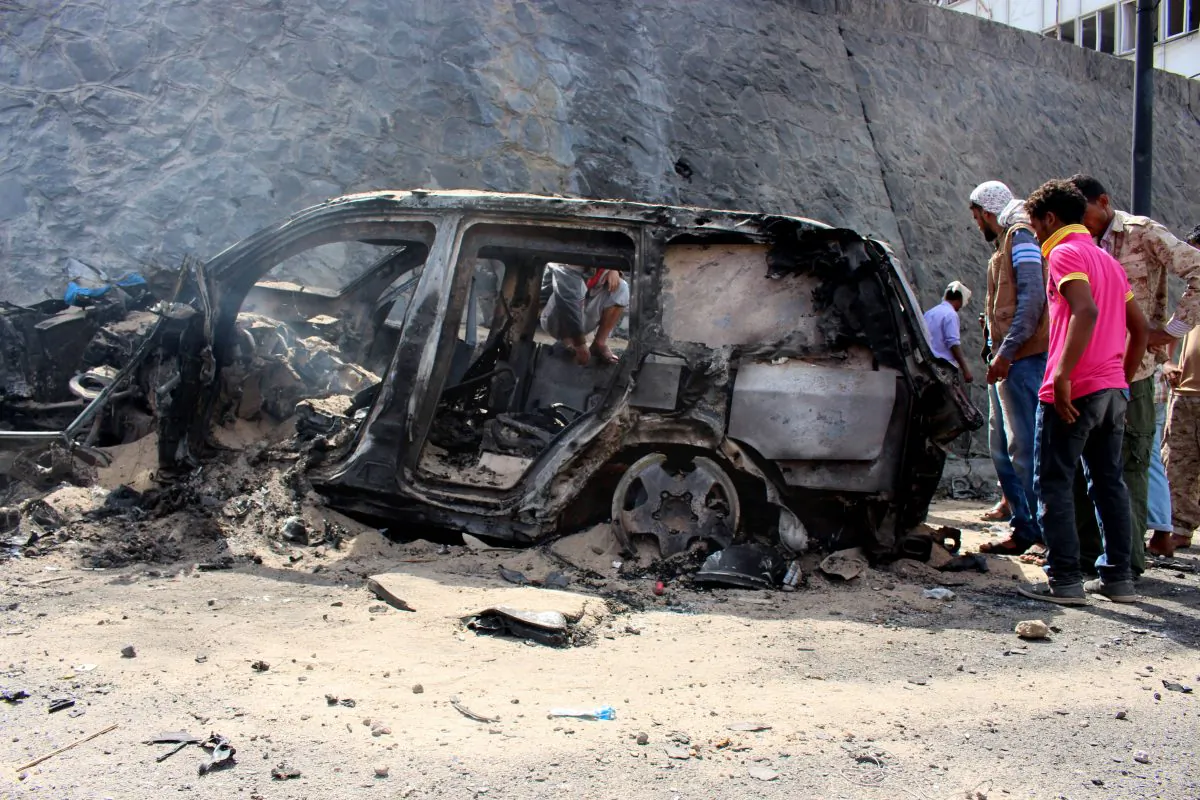 Yemenis inspect the scene of a car bomb attack that killed a Yemeni senior official in the southern port city of Aden, Yemen, Sunday, Dec. 6, 2015. A huge explosion killed the governor of Yemen's southern Aden province and six of his bodyguards on Sunday, security officials said, in an attack that was later claimed by a local Islamic State affiliate. (AP Photo/Wael Qubady)