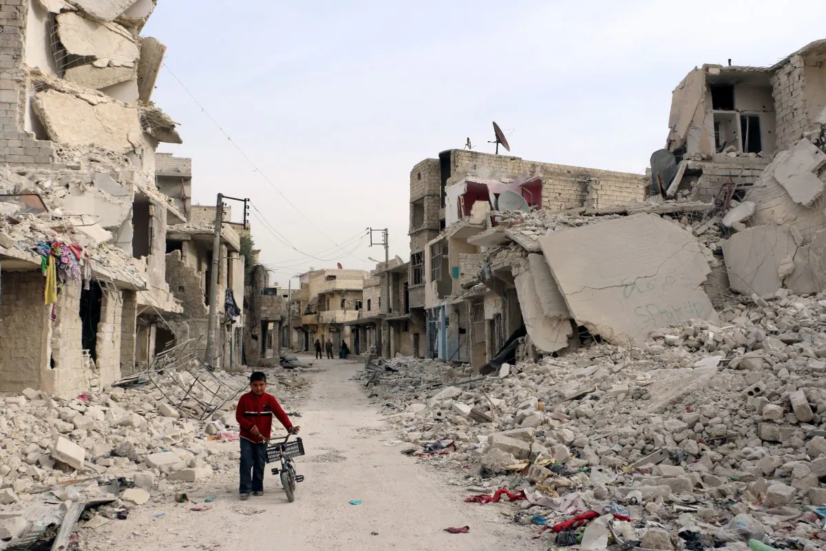A Syrian boy walks with his bicycle in the devastated Sukari District in the northern Aleppo City on Nov. 13, 2014. (Baraa al-Halabi/AFP/Getty Images)