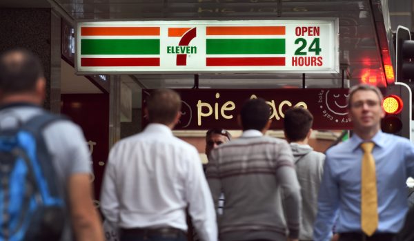 People walk past a 7-Eleven convenience store in Sydney's central business district in Australia, on Sept. 30, 2015. (William West/AFP/Getty Images)