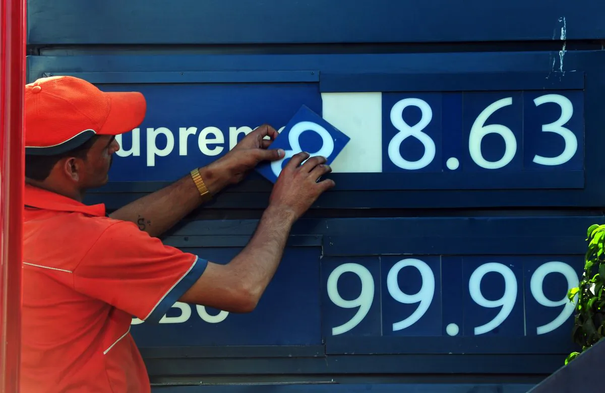 A Pakistani employee changes the oil prices on a billboard in Karachi on May 1, 2011. (ASIF HASSAN/AFP/Getty Images)