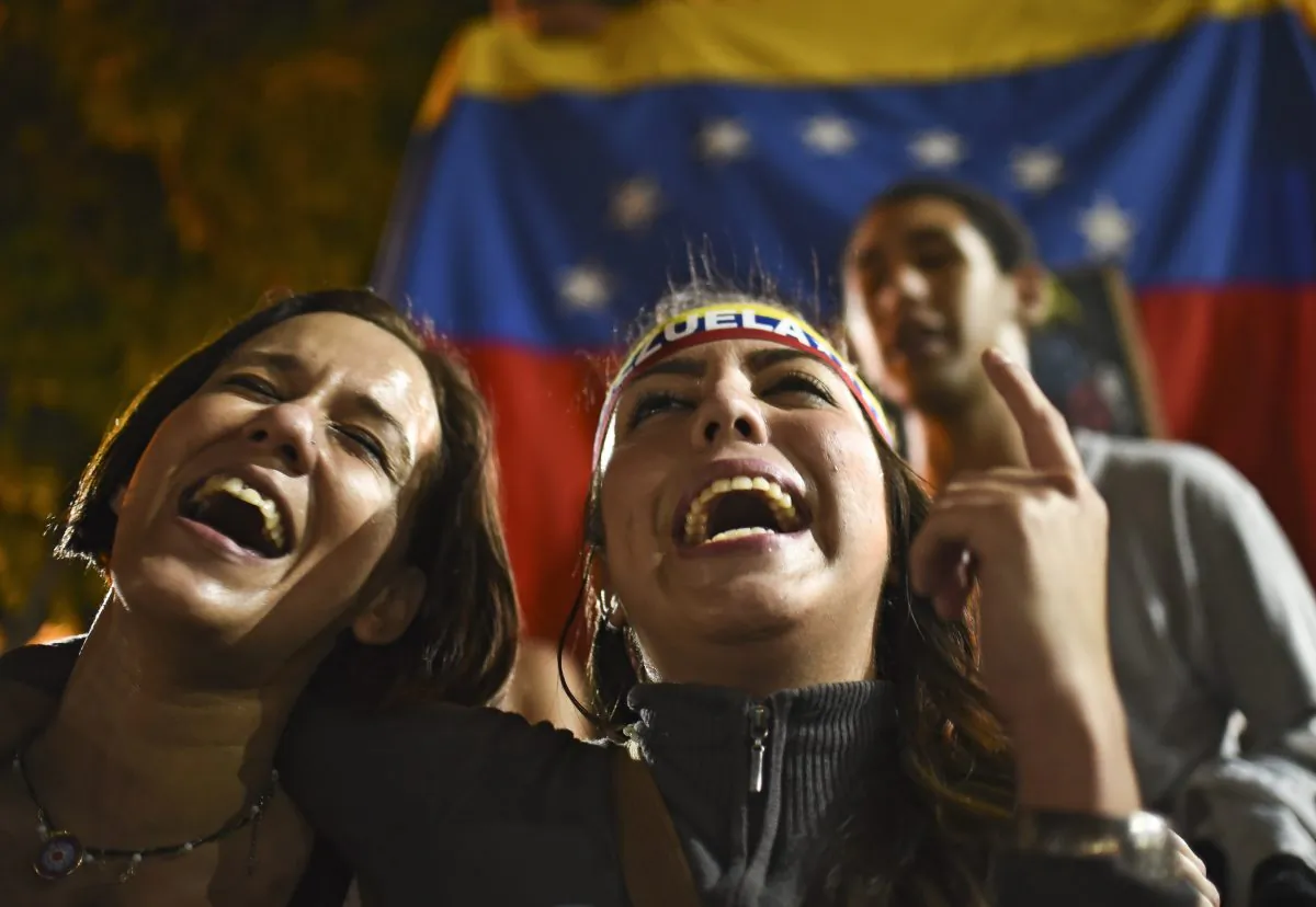 Venezuelan opposition supporters celebrate the results of the legislative election in Caracas on Dec. 7, 2015. Venezuela's jubilant opposition vowed Monday to drag the oil-rich country out of its economic crisis and free political prisoners after winning control of congress from socialist President Nicolas Maduro. (Luis Robayo/AFP/Getty Images)