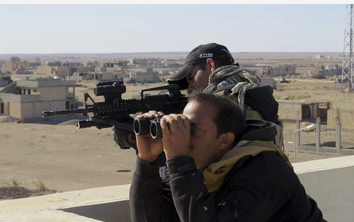 Soldiers of Iraq anti-terrorism forces watch movements during a military operation to regain control of the western suburbs of Ramadi, Anbar Province, Iraq, on Nov. 14, 2015.  (AP Photo/Osama Sami)