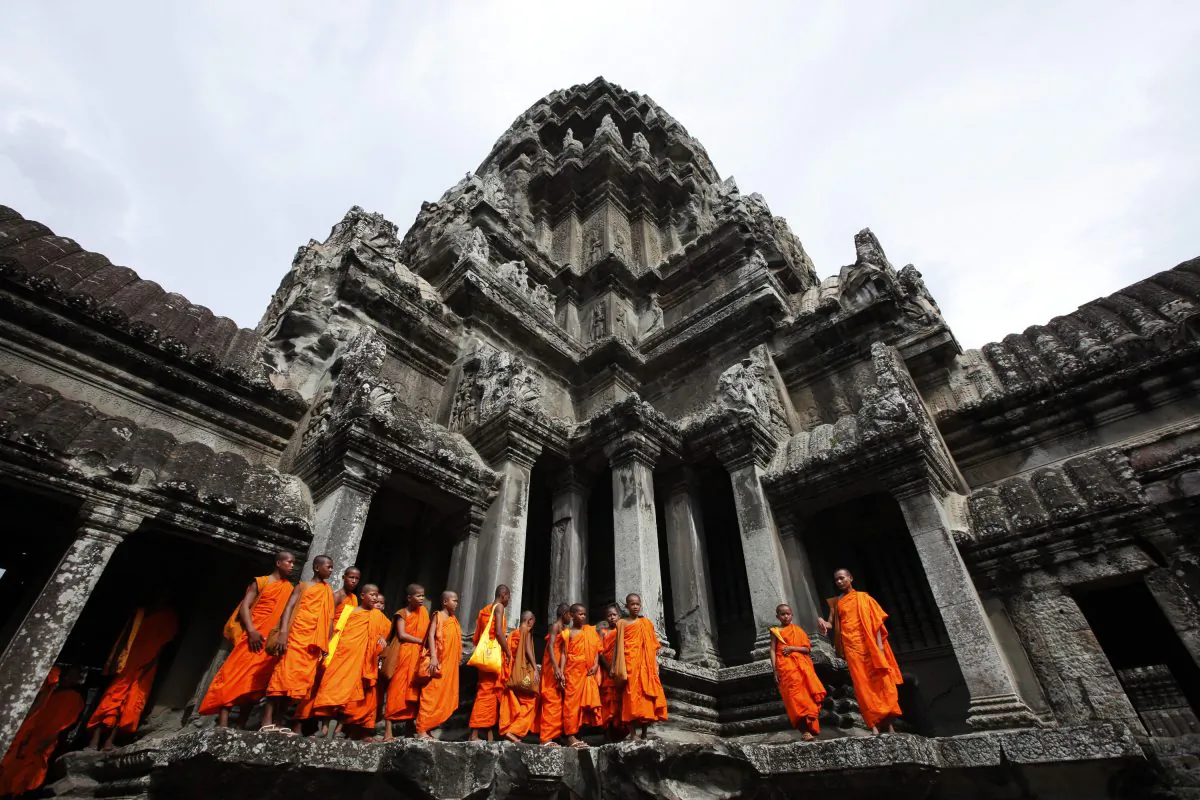 Buddhist monks stroll through the ancient Angkor Wat temple in Siem Reap province in Cambodia on July 16, 2010. (Eugene Hoshiko/AP Photo)