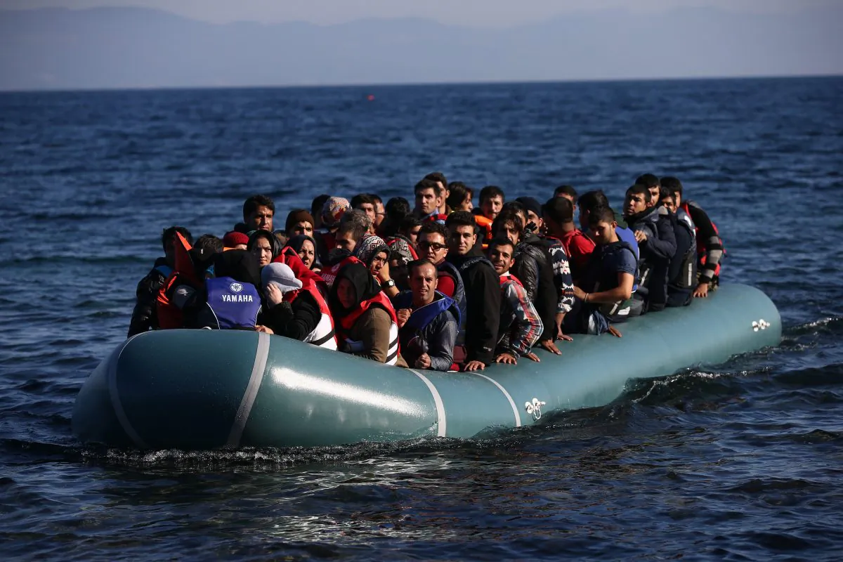 A migrant boat arrives after making the crossing from Turkey to the Greek island of Lesbos, in Sikaminias, Greece, on Nov. 12, 2015. Rafts and boats continue to make the journey from Turkey to Lesbos each day as thousands flee conflict in Iraq, Syria, Afghanistan, and other countries. Over 500,000 migrants have entered Europe so far this year and approximately four-fifths of those have paid to be smuggled by sea to Greece from Turkey, the main transit route into the EU. (Carl Court/Getty Images)