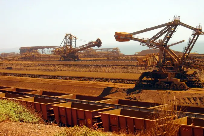 Remote-controlled stackers and reclaimers move iron ore to railcars in Pilbara, Australia, on March 4, 2010. (Amy Coopes/AFP/Getty Images)