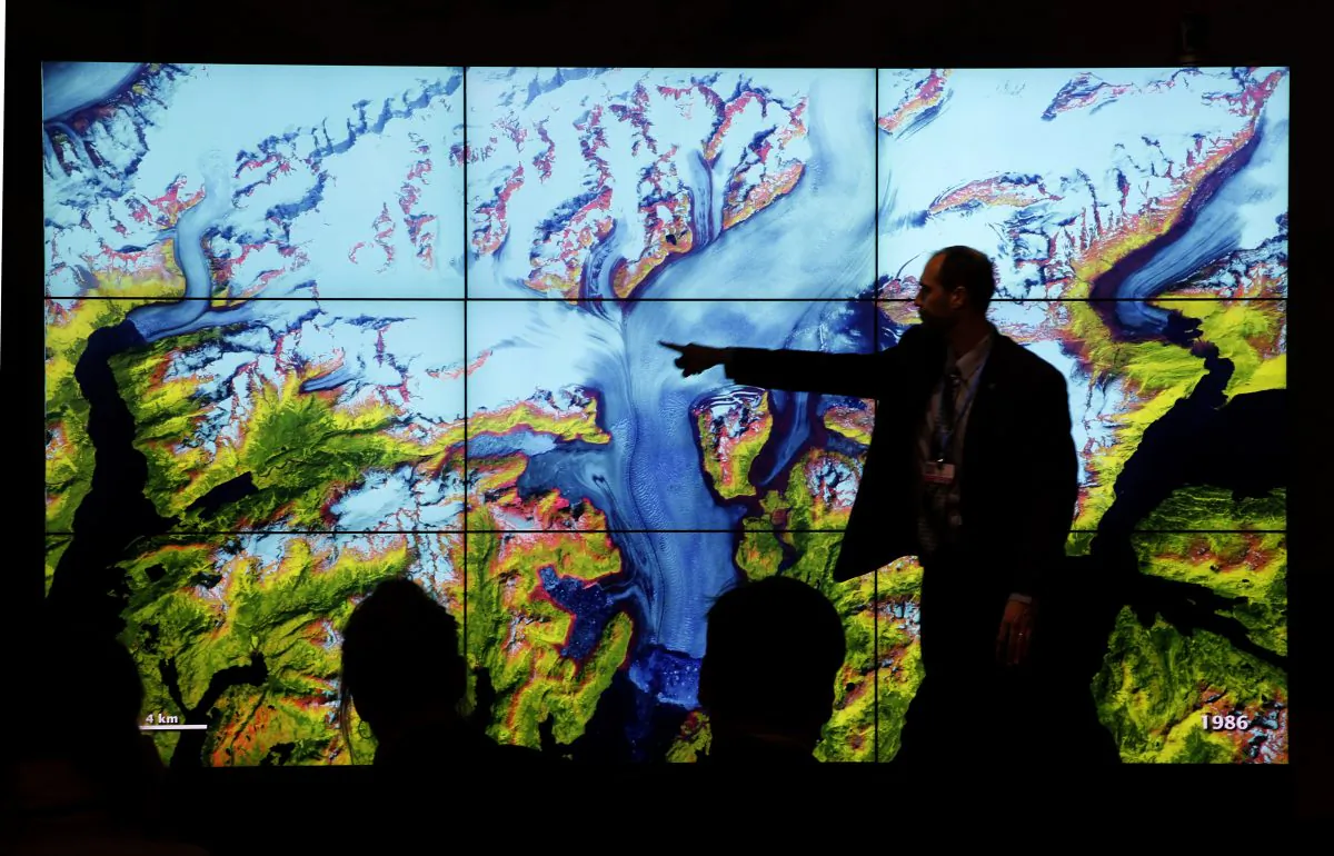 People attend a climate conference at the U.S. pavilion during the COP21, United Nations Climate Change Conference in Le Bourget, north of Paris, Thursday, Dec. 10, 2015. (AP Photo/Christophe Ena)