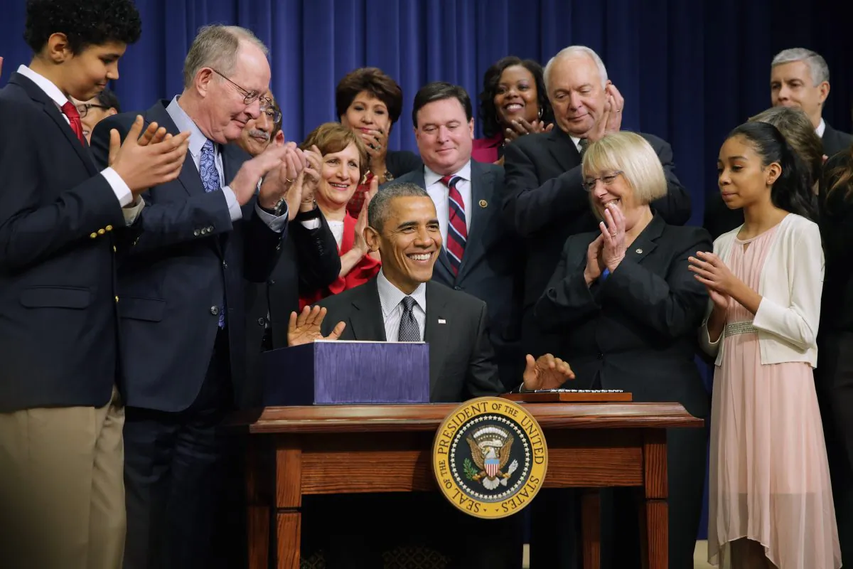 Members of Congress, education leaders and students applaud after President Barack Obama signed The Every Student Succeeds Act during a ceremony in the Eisenhower Executive Office Building in Washington, D.C., on Dec. 10, 2015. (Chip Somodevilla/Getty Images)
