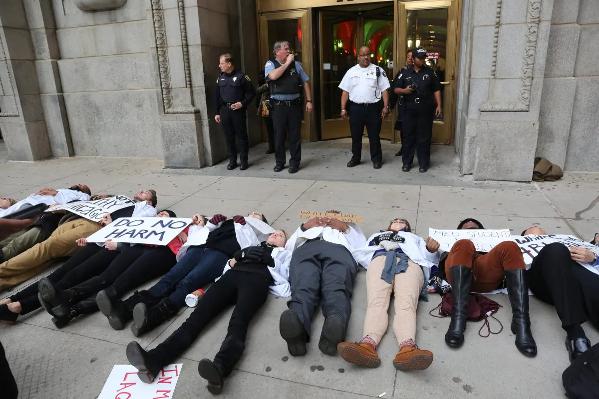 Dozens of medical students from various Chicago student associations stage a "die in" outside the county building, Thursday, Dec. 10, 2015, to protest the killing of Laquan McDonald by a police officer in Chicago. Many activists and analysts say the steps Mayor Rahm Emanuel is taking to hold Chicago police officers accountable for abuses are way too timid. It's tinkering at the edges of deeply flawed structures or merely switching around managers, they argue, when what's needed is to scrap the entire system and start all over.(Antonio Perez/Chicago Tribune)