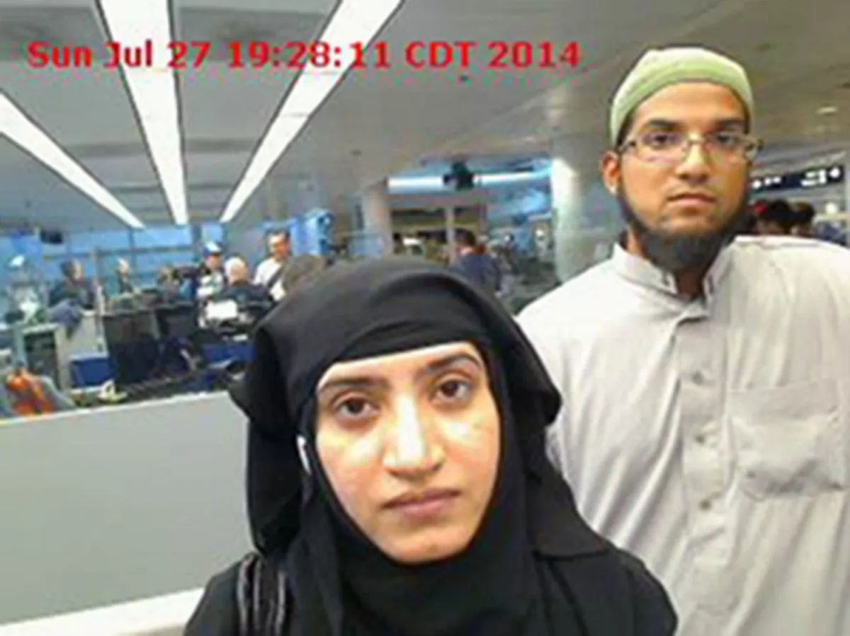 This July 27, 2014 file photo provided by U.S. Customs and Border Protection shows Tashfeen Malik, left, and Syed Farook, as they passed through O'Hare International Airport in Chicago. (U.S. Customs and Border Protection via AP, File)