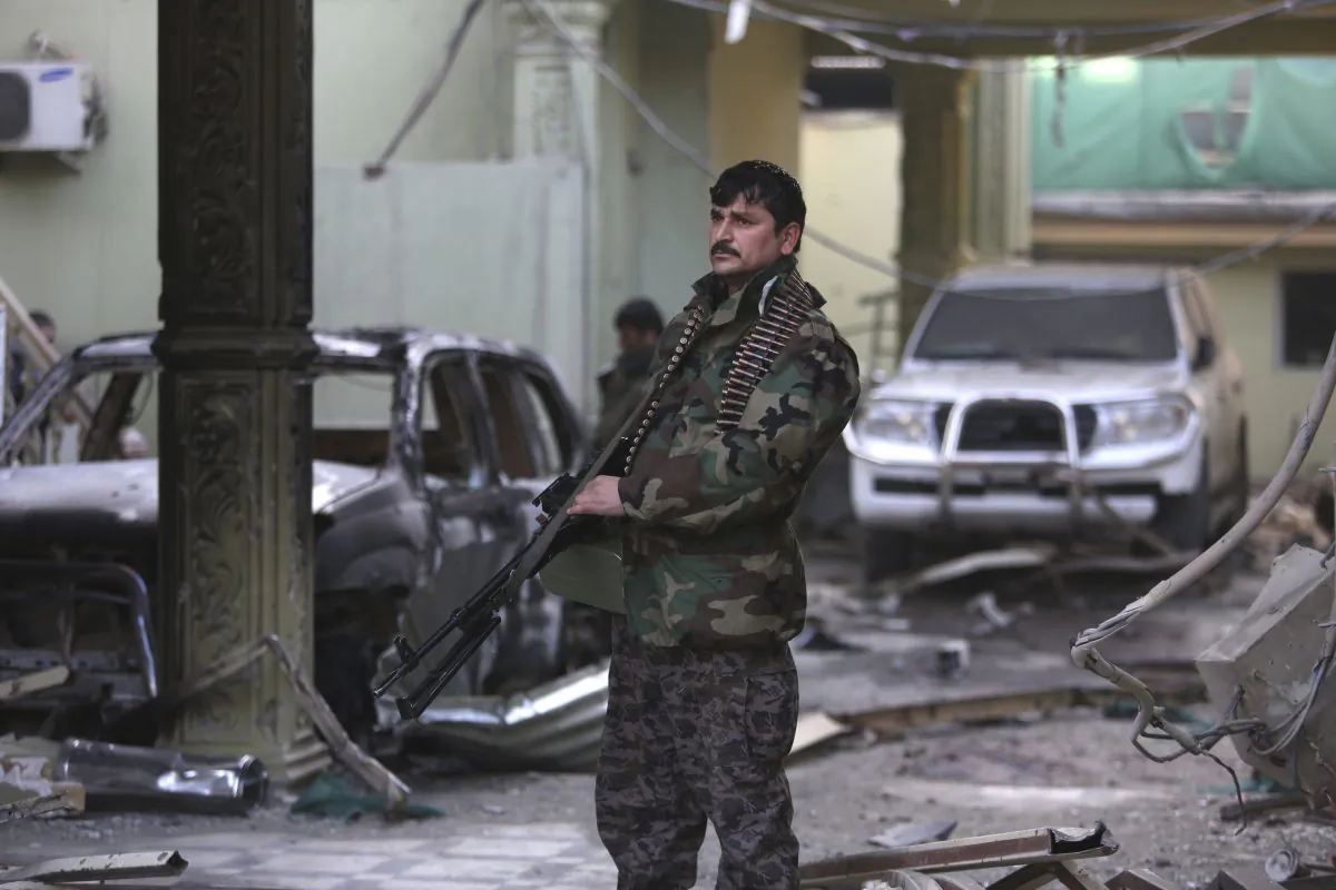 An Afghan security forces member stands guard at the Spanish Embassy after an attack in Kabul, Afghanistan, Saturday, Dec. 12, 2015. (AP Photo/Rahmat Gul)