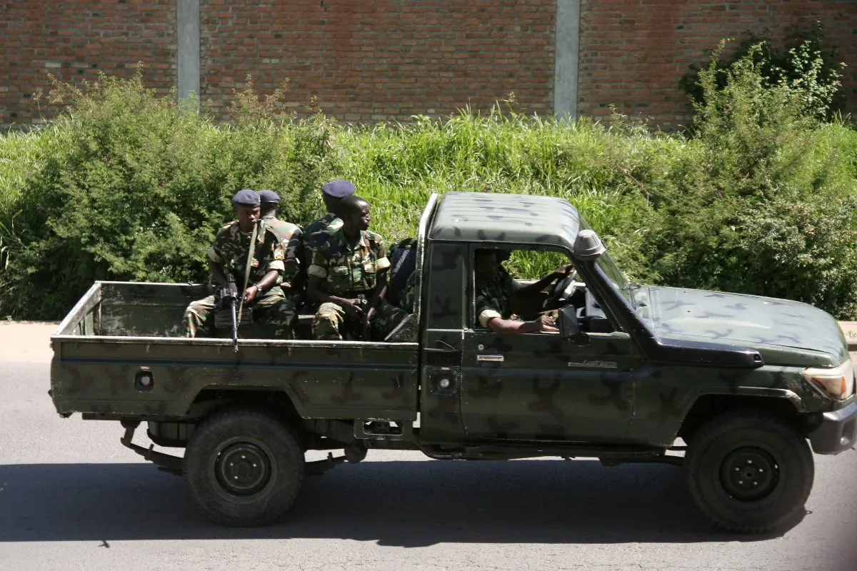Military personnel sits aboard a vehicle driving through the Musaga neighbourhood of the city of Bujumbura, Burundi, on Dec. 11, 2015. (Stringer/AFP/Getty Images)