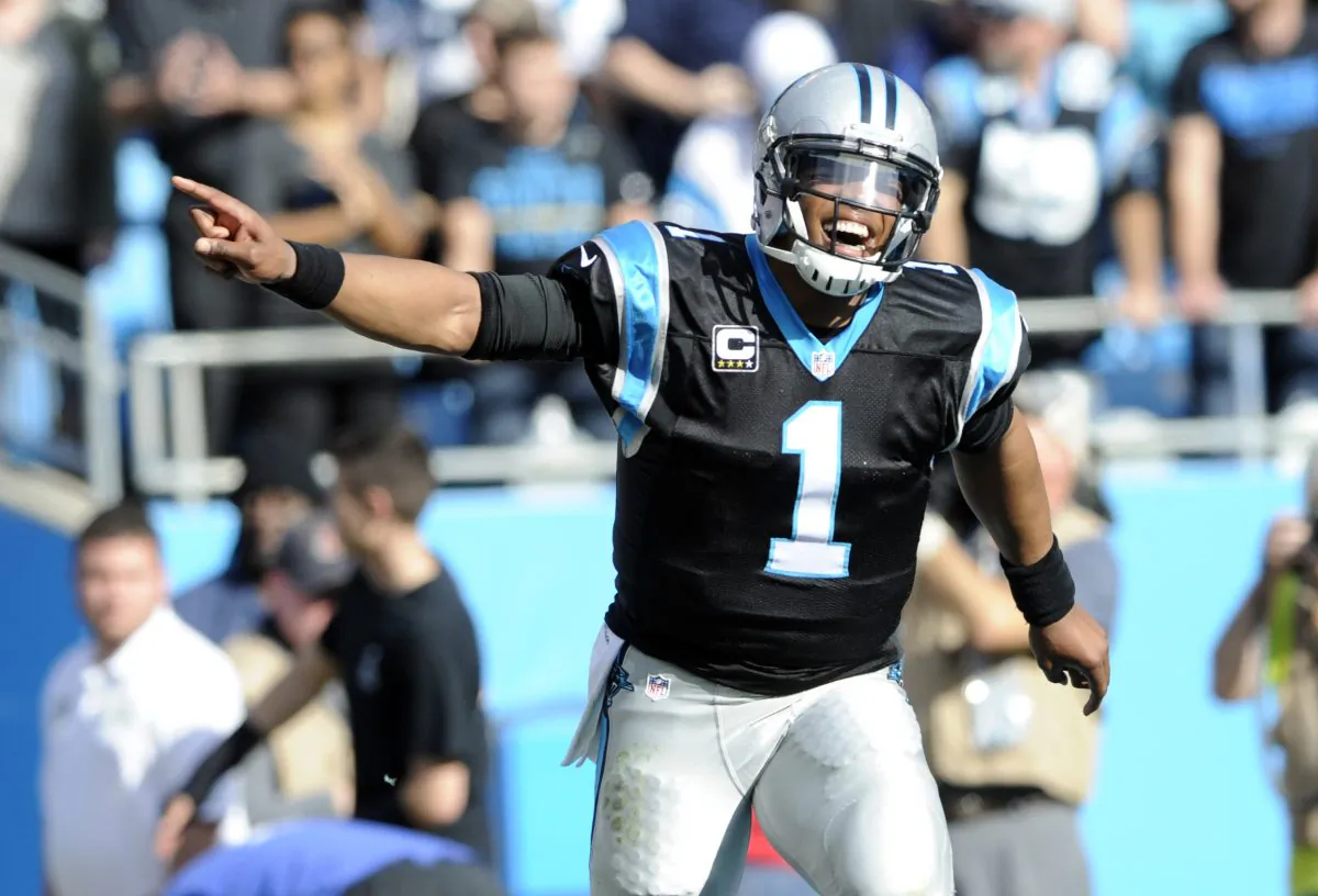 Cam Newton threw for 265 yards and 3 TDs in the 38–0 win, in a file photo. (Mike McCarn/AP Photo)