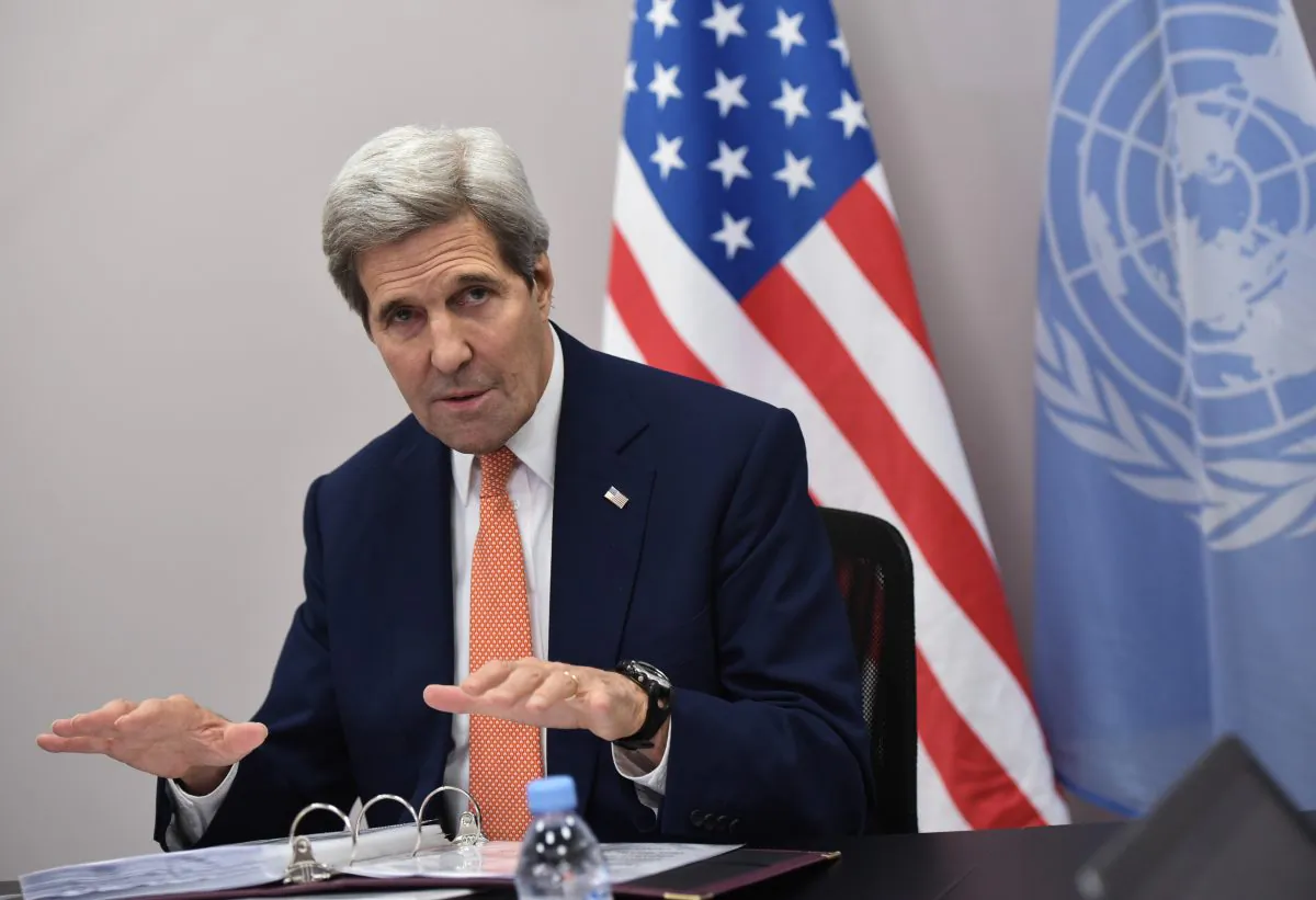 US Secretary of State John Kerry speaks to the traveling press following the COP21 U.N. conference on climate change in Le Bourget, near Paris, on Dec. 12, 2015. (Mandel Ngan/Pool Photo via AP)