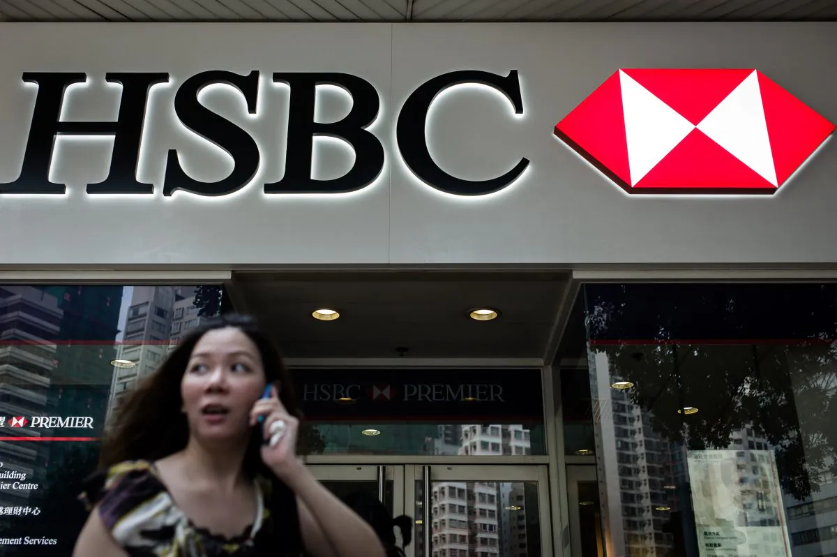 A woman stands outside of a HSBC branch in Hong Kong on July 8, 2014. (Philippe Lopez/AFP/Getty Images)