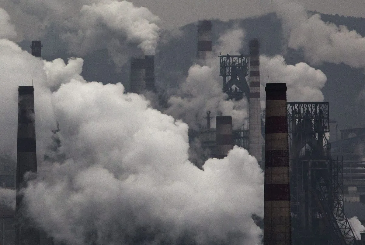 Smoke billows from smokestacks and a coal fired generator at a steel factory in the industrial province of Hebei, China, on Nov. 19, 2015. (Kevin Frayer/Getty Images)