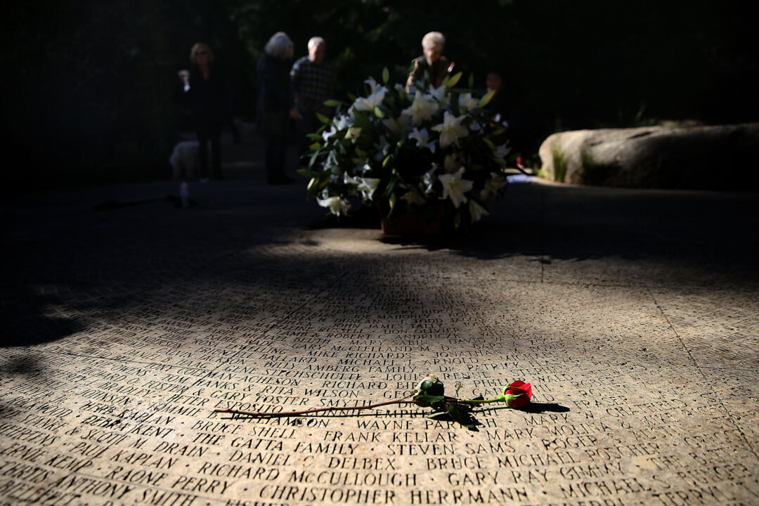 A flower lays on the engraved names of AIDS victims at the National AIDS Memorial Grove in San Francisco, Calif., on Dec. 1, 2015. World AIDS Day has been observed on Dec. 1 since 1988, and is dedicated to raising awareness of the AIDS pandemic caused by the spread of HIV infection, and to mourn those who have died from the disease. (Justin Sullivan/Getty Images)